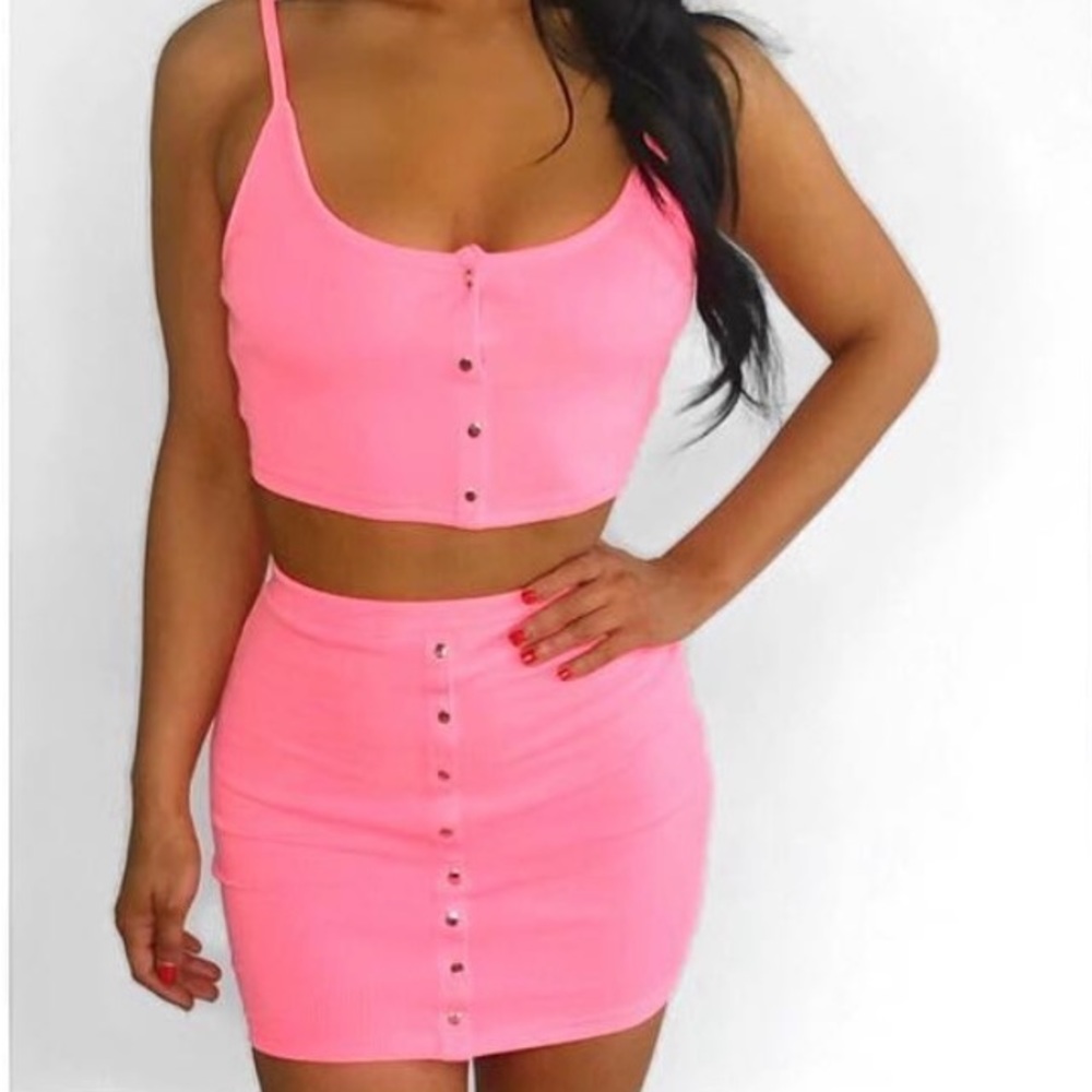 Pink, cotton material skirt with silver buttons.